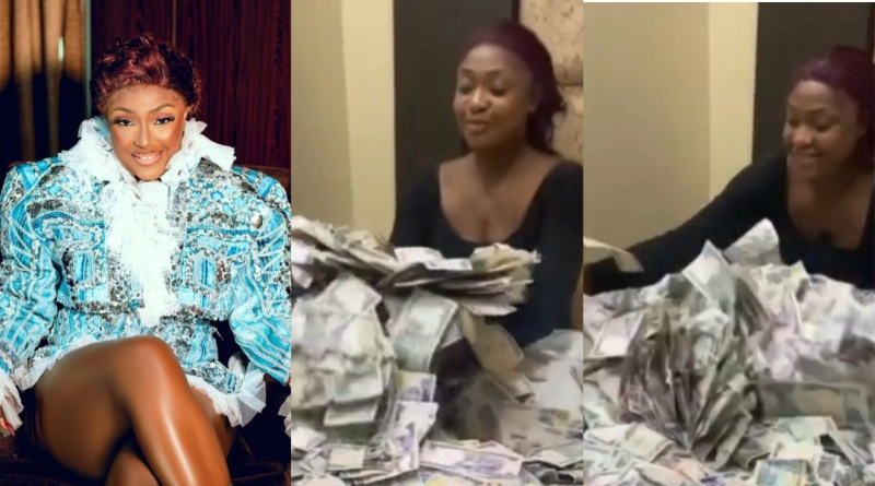 Actress Lizzy Gold displays the wad of cash she was doused with during her birthday party.